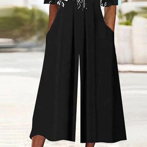 Combinaison noire à manches mi-longues et imprimé floral